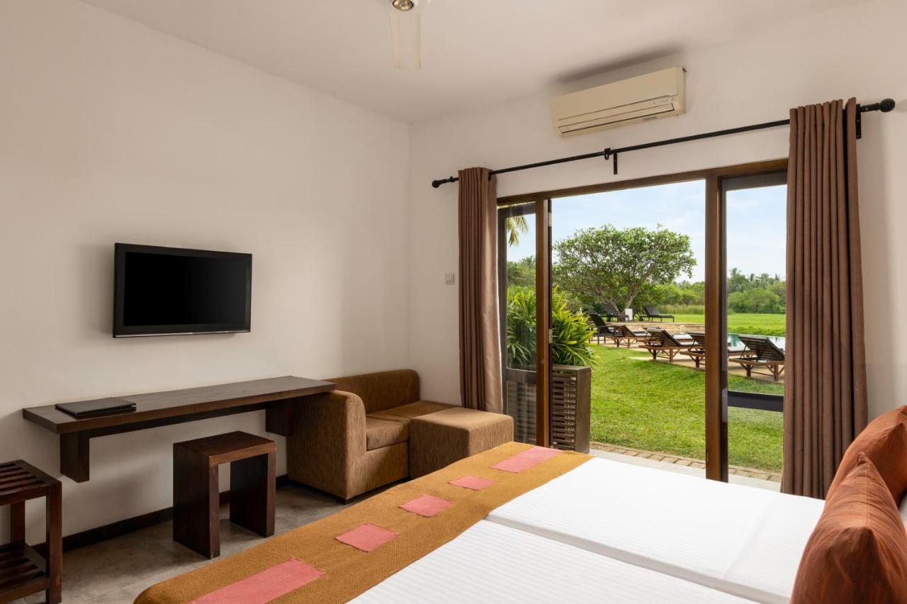Deluxe Double a glass of traditional lassi overlooking paddy fields enjoy tea or coffee evening snacks